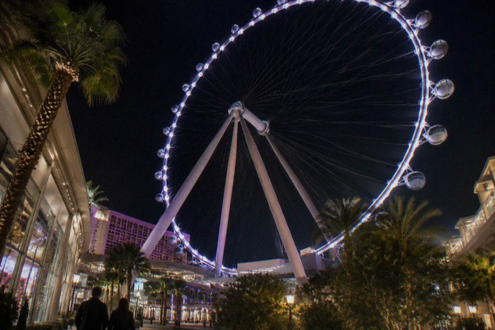 The illuminated High Roller observation wheel rising above the Strip at night