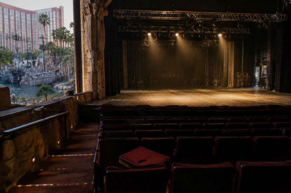 Theater stage lit with warm spotlights before a performance