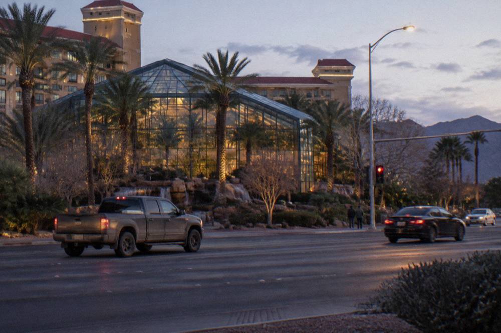 A Las Vegas resort corridor with light traffic on the road at dusk in winter