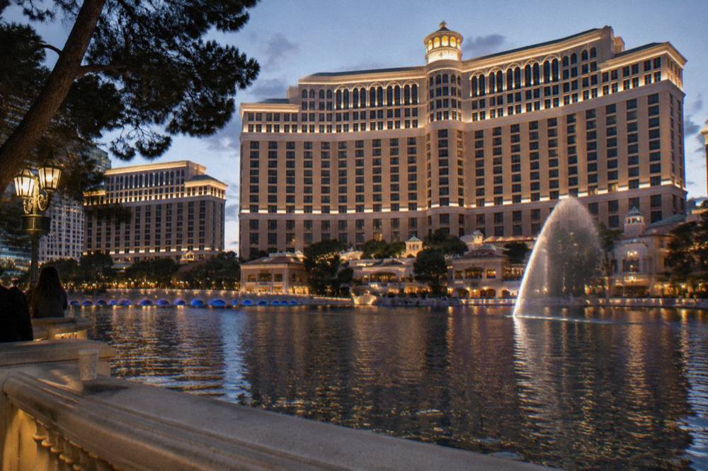 Glowing holiday lights and a resort facade on a clear December evening