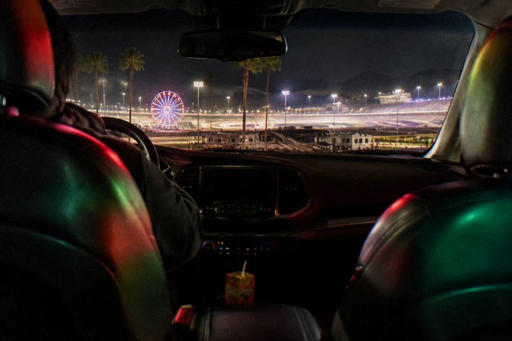 A family car interior glowing with colorful light reflections at night