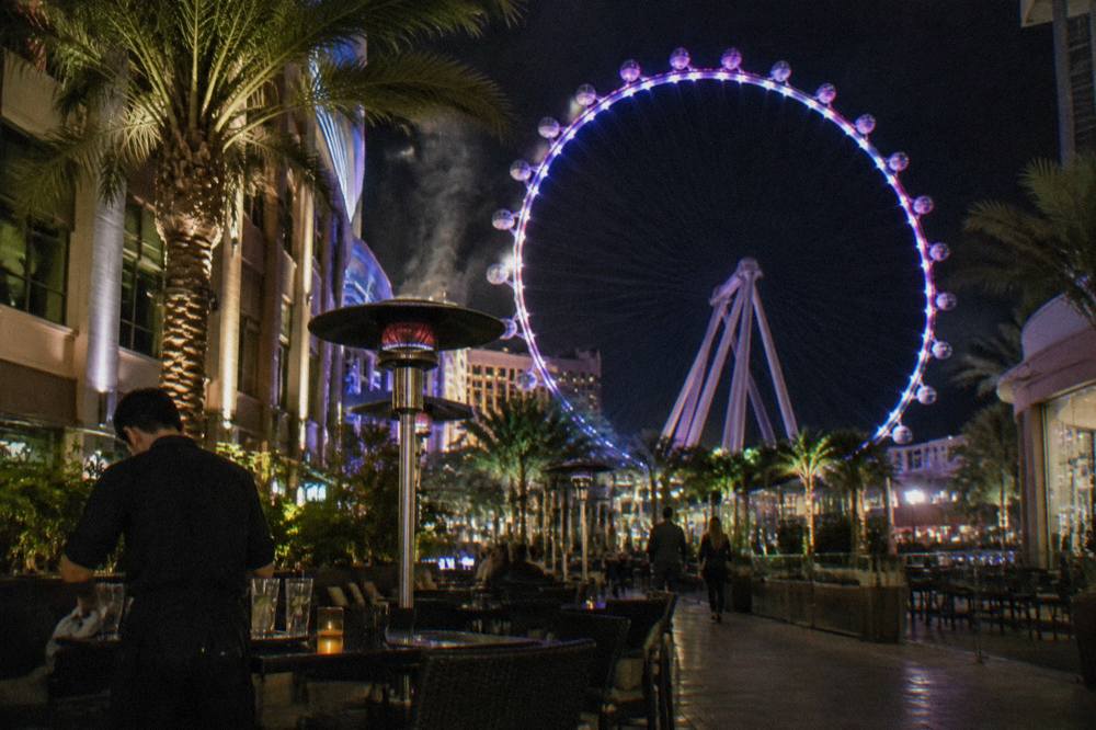 The illuminated High Roller wheel rising above the LINQ promenade after dark