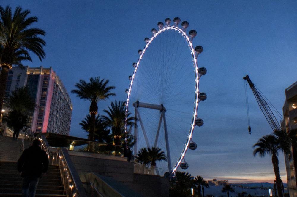 The High Roller wheel's lit rim against a deep blue twilight sky above the Strip