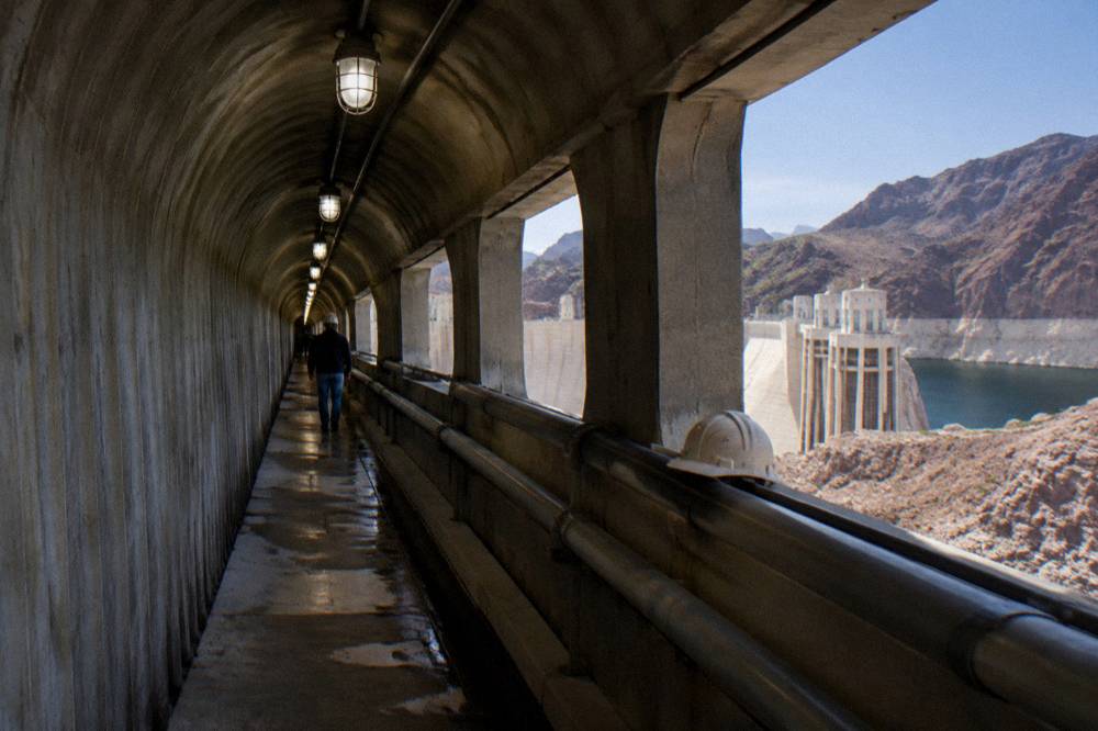 Interior passage inside Hoover Dam with concrete walls and industrial lighting