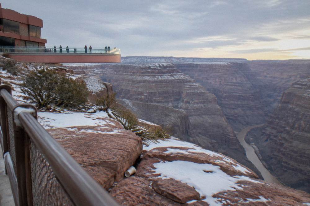 Canyon rim view with dusting of snow on red rock ledges