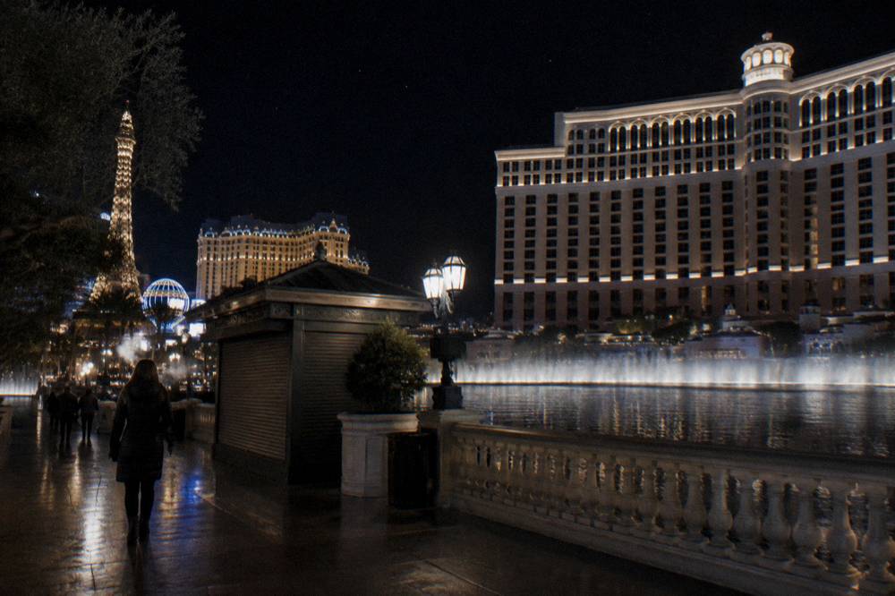A lit boulevard at night in winter with a cold clear sky above the resort towers
