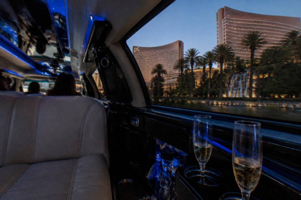 A stretch limousine interior with leather seating and soft lighting