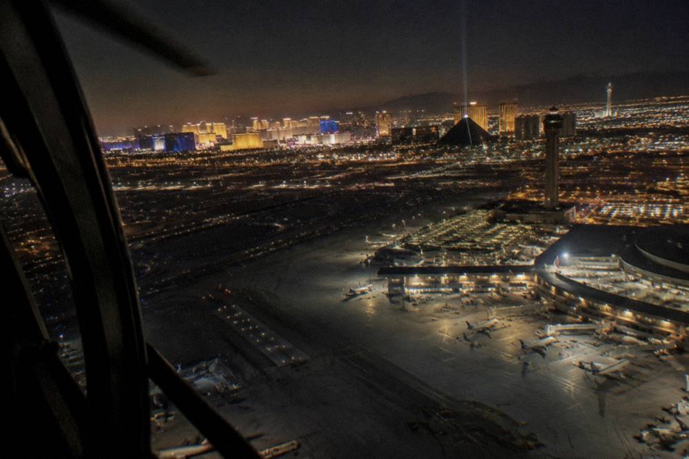 Helicopter cockpit view of the Las Vegas Strip illuminated at night